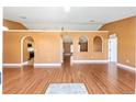 Open living room with hardwood floors and arched doorways at 3011 Se 46Th Ave, Ocala, FL 34480