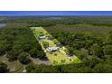 Expansive acreage featuring a charming home nestled among lush trees, with plenty of open space and a long driveway at 3360 Se 183Rd Avenue Rd, Ocklawaha, FL 32179