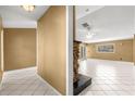 Spacious living room featuring tiled floors and a stone fireplace, ideal for entertaining guests at 5580 Se 21St Ln, Ocala, FL 34480