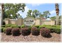 The Deer Path Estates community sign, surrounded by lush greenery and manicured bushes at 6365 Se 12Th Ln, Ocala, FL 34472
