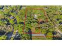 Aerial view of the property highlighting land's boundaries and surrounding lush greenery at 6700 Nw 57Th Ave, Ocala, FL 34482