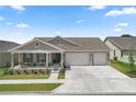 Charming single-story home featuring a covered porch, two-car garage, and well-maintained landscaping at 7687 Sw 63Rd Place Rd, Ocala, FL 34474