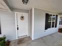 Inviting front entrance with a decorative wreath on a classic white door at 8045 Sw 108Th Loop, Ocala, FL 34481