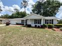Well-maintained single-story home with green lawn and tidy garden beds at 8045 Sw 108Th Loop, Ocala, FL 34481