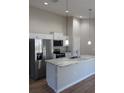 This open kitchen boasts stainless steel appliances, granite countertops, and sleek pendant lighting at 8661 Juniper Rd, Ocala, FL 34480