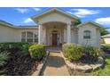 Inviting home entrance with manicured landscaping leading to the front door at 8895 Sw 57Th Court Rd, Ocala, FL 34476