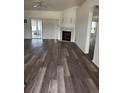 Spacious living room features a fireplace, sliding glass doors, and new flooring at 8895 Sw 57Th Ct Rd, Ocala, FL 34476