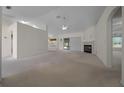 Open-concept living room with neutral carpeting and a fireplace at 8895 Sw 57Th Court Rd, Ocala, FL 34476