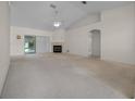 Bright living room featuring a fireplace, ceiling fan, and sliding glass doors at 8895 Sw 57Th Court Rd, Ocala, FL 34476