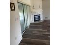 Living room features a fireplace, sliding glass door, and new flooring at 8895 Sw 57Th Ct Rd, Ocala, FL 34476