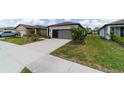 A view of a well-maintained single-story home with a grey garage door at 8951 Sw 58Th Street Rd, Ocala, FL 34481