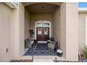 Welcoming front porch featuring seating and a double door, inviting guests into the home at 9074 Se 48Th Court Rd, Ocala, FL 34480