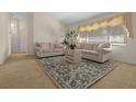 Inviting living room featuring neutral tones, plush seating, and a decorative area rug at 10337 Sw 74Th Ter, Ocala, FL 34476