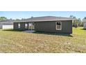 The backyard has a sliding glass door that provides access to indoor/outdoor living at 10374 Se 126Th Ln, Belleview, FL 34420