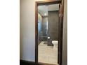 Modern bathroom featuring sleek dark gray tiling, a glass-enclosed shower, and stylish fixtures at 1047 Ne 19Th St, Ocala, FL 34470