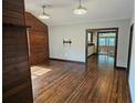 Bright living room with hardwood floors and a view into the kitchen with natural light throughout the home at 1047 Ne 19Th St, Ocala, FL 34470