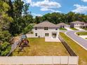 Aerial view of the property featuring a fenced backyard, brick patio, and a playset at 11136 Se 69Th Ter, Belleview, FL 34420