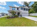 Charming two-story home with a well-manicured lawn, fresh landscaping, and a two-car garage at 11136 Se 69Th Ter, Belleview, FL 34420