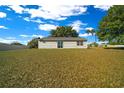 Expansive backyard featuring a sliding glass door leading to the home's interior at 1115 Silver Rd, Ocala, FL 34472