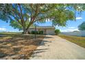 Well-maintained ranch-style home with an attached garage and long concrete driveway at 1115 Silver Rd, Ocala, FL 34472