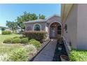 The arched entryway and landscaped yard welcome you to this charming three car garage home at 1213 Meadowbend Dr, Leesburg, FL 34748