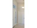 Bright entryway featuring high ceilings, tile floors, and double doors at 13154 Sw 69Th Ct, Ocala, FL 34473