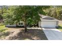 Charming single-story home with stone accents, a two-car garage, and a well-manicured front lawn at 13164 Sw 78Th Place, Dunnellon, FL 34432