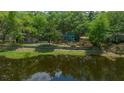A view of the home from the water, with mature trees and a waterfront location at 14190 Ne 209Th Ct, Fort Mc Coy, FL 32134