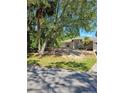 Serene single-story home enhanced by mature trees, a well-kept lawn, and charming front yard landscaping at 1441 Admiral Nimitz Ave, Daytona Beach, FL 32124
