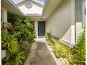 Inviting front entrance with lush landscaping leading to a stylish front door at 15426 Sw 14Th Avenue Rd, Ocala, FL 34473