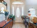 Inviting entryway with decorative glass door and sidelights, complemented by elegant furnishings and tile flooring at 17901 Sw 25Th Avenue Rd, Ocala, FL 34473
