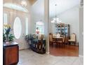 Elegant foyer leading to a dining area, featuring tile flooring and stylish decor that enhances the home's aesthetic at 17901 Sw 25Th Avenue Rd, Ocala, FL 34473