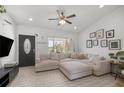 Bright living room showcasing a large sectional sofa, stylish front door, and plenty of natural light at 2705 Sw 156Th Lane Rd, Ocala, FL 34473
