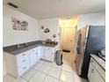 Efficient kitchen space with granite countertops, ample cabinet storage, and tile flooring at 5606 Sw 107Th St, Ocala, FL 34476
