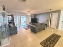 Comfortable living room featuring tile flooring, neutral paint, and sliding door access to the outdoors at 5606 Sw 107Th St, Ocala, FL 34476
