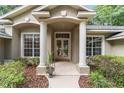 Inviting front entrance with decorative columns, detailed brickwork, and manicured landscaping at 733 Se 67Th Ln, Ocala, FL 34480