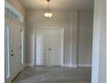 Light-filled entryway with tile flooring, white doors, and transom window above the front door at 8344 Sw 57Th Ct, Ocala, FL 34476