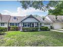 Charming single-story home with manicured lawn, mature trees, and an attached garage at 8351 Sw 93Rd Ln # D, Ocala, FL 34481