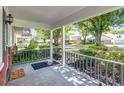 Inviting front porch with brick accents, offering a view of the serene, tree-lined street at 8351 Sw 93Rd Ln # D, Ocala, FL 34481