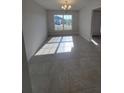 Inviting dining room featuring tile floors, large window, and ample natural light for comfortable dining at 8468 Sw 59Th Ter, Ocala, FL 34476