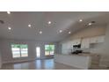 Bright, open-concept living space with recessed lighting, tile flooring, and a seamless transition to the kitchen at 8468 Sw 59Th Ter, Ocala, FL 34476