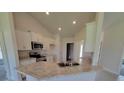Bright kitchen featuring stainless steel appliances and granite countertops at 8482 Sw 59Th Ter, Ocala, FL 34476