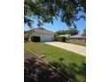 Charming one-story home boasts a two car garage and long driveway at 9012 Sw 91St Cir, Ocala, FL 34481