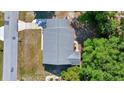 Aerial perspective displaying roof features, the surrounding lawn, and tree coverage in the neighborhood at 9058 Sw 108Th Pl, Ocala, FL 34481