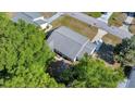 An aerial view of the home showing its roof and proximity to mature trees and the surrounding neighborhood at 9058 Sw 108Th Pl, Ocala, FL 34481