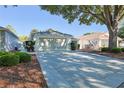 Spacious two-car garage with a long driveway and meticulous landscaping at 9088 Sw 95Th Ave, Ocala, FL 34481