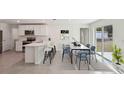 Open-concept kitchen and dining area with stainless steel appliances and ample seating at 13032 Sw 84Th Terrace Rd, Ocala, FL 34473