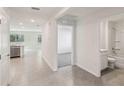 Open-concept entryway featuring neutral tile flooring, with views of the kitchen, living area, and bathroom at 13032 Sw 84Th Terrace Rd, Ocala, FL 34473