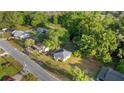 Charming home with a metal roof surrounded by lush greenery and a well-maintained lawn at 1309 Ne 33Rd St, Ocala, FL 34479