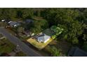 Charming home with a metal roof surrounded by lush greenery and a well-maintained lawn at 1309 Ne 33Rd St, Ocala, FL 34479